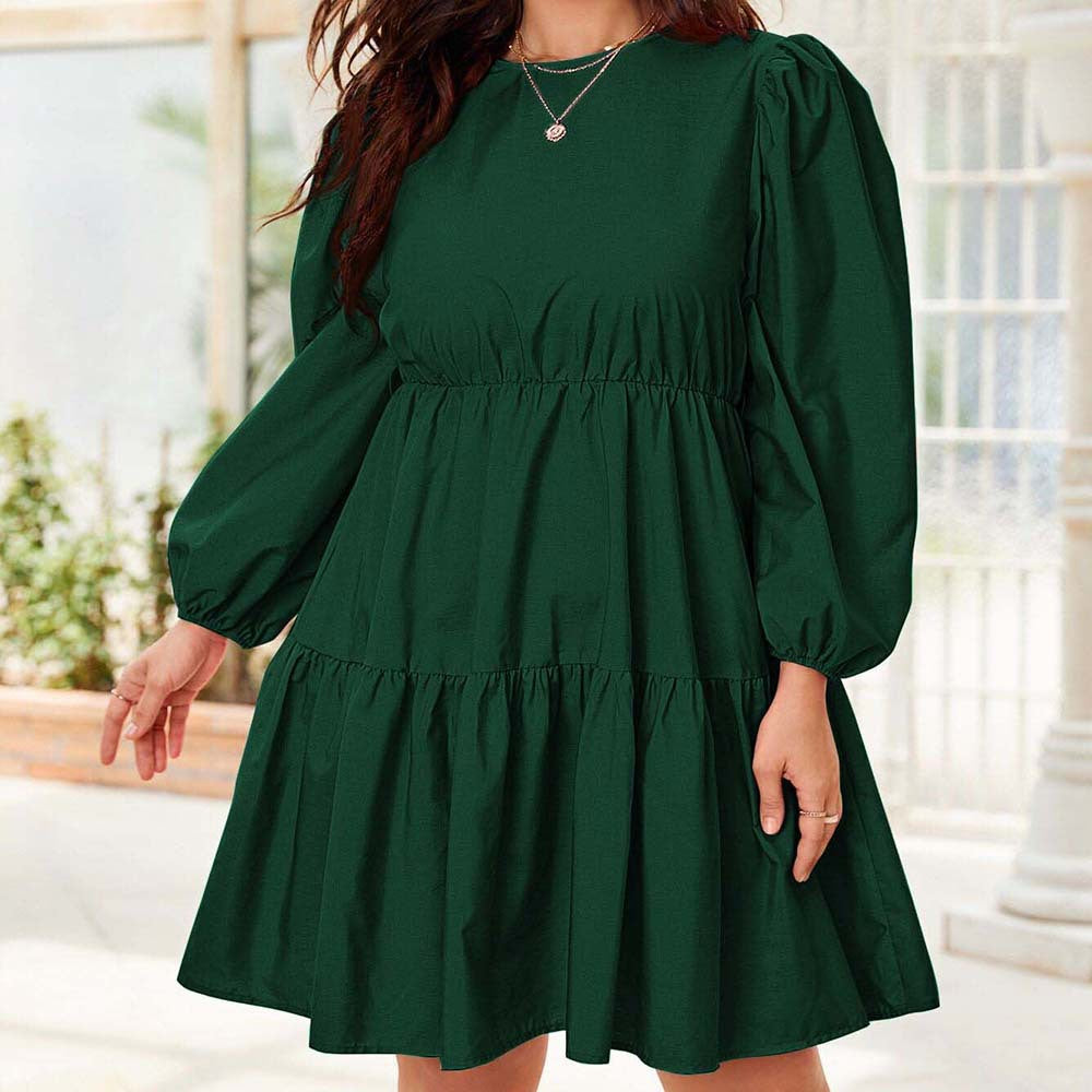 Emerald green tiered dress featuring elegant lantern sleeves, perfect for chic fashion statements