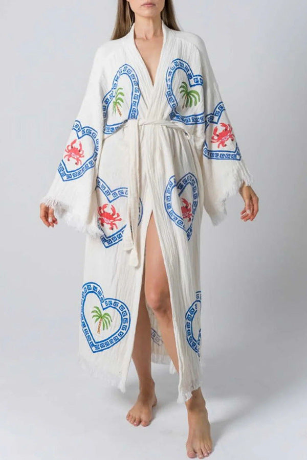 White long-sleeved loose positioning printed coat with blue hearts, palm trees, and crabs