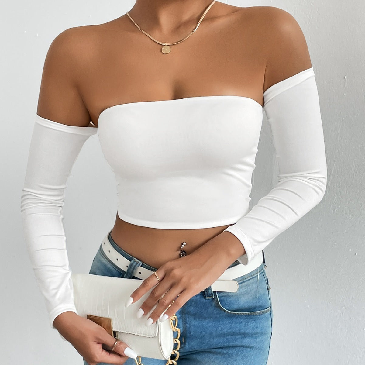 White off-the-shoulder long-sleeve crop top showcasing modern langry fashion and ملابس style