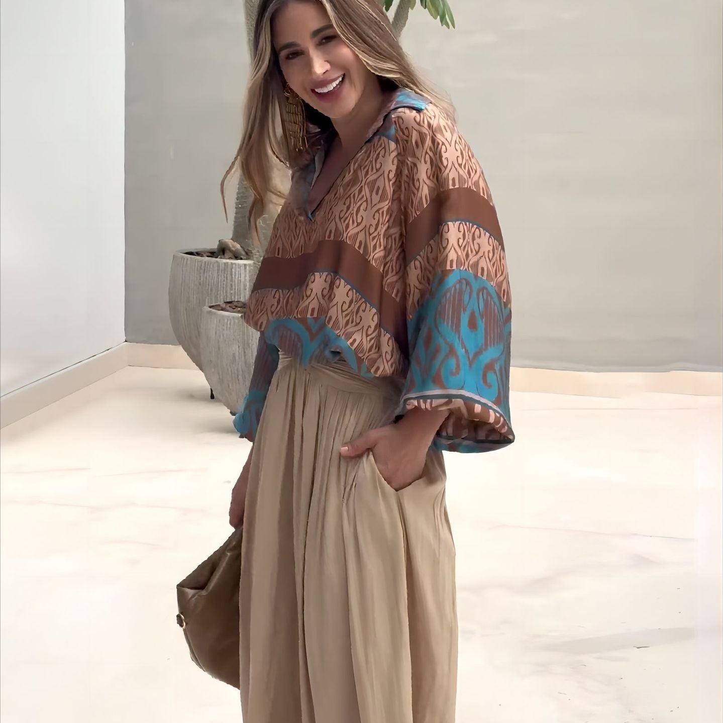 Elegant two piece set featuring woman in patterned blouse and wide-leg pants with free shipping