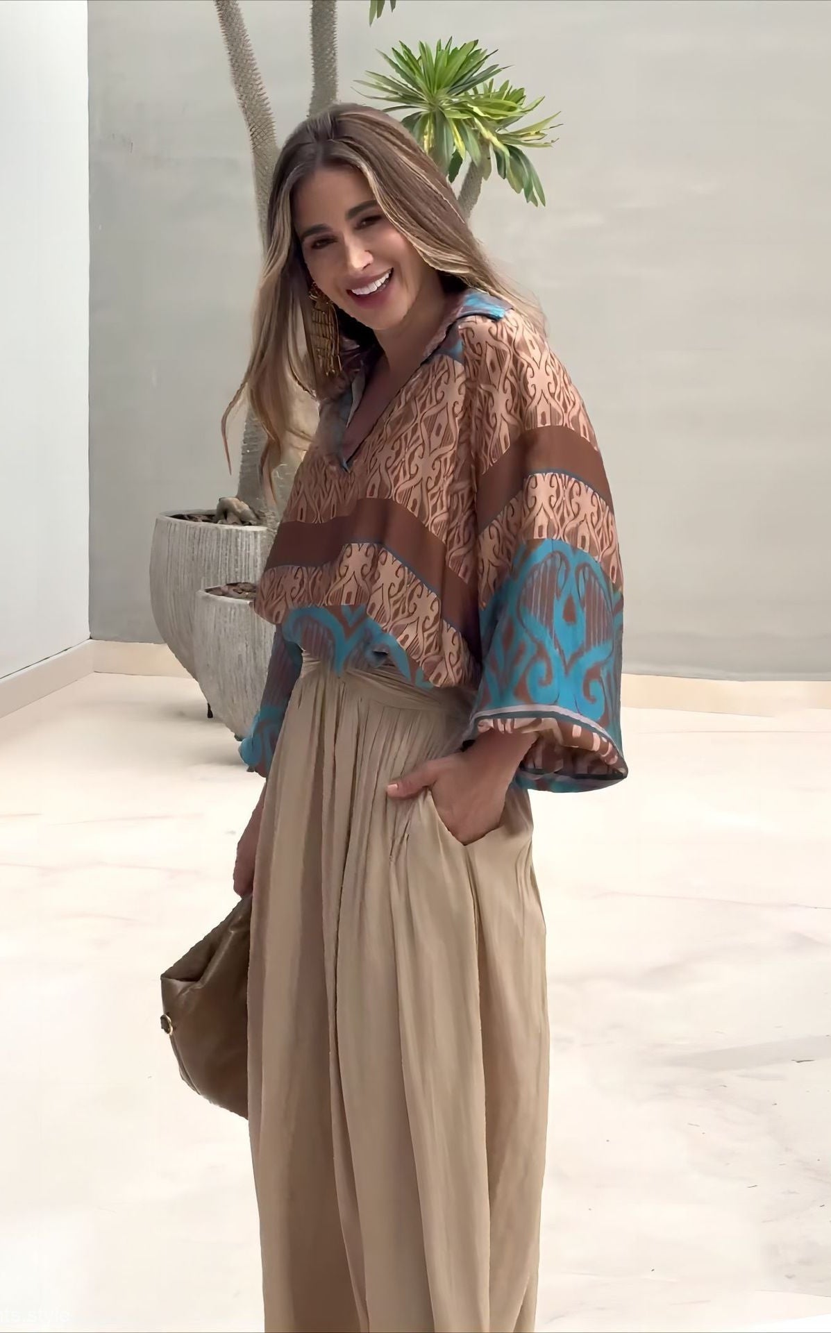 Elegant two piece set featuring woman in patterned blouse and wide-leg pants with free shipping