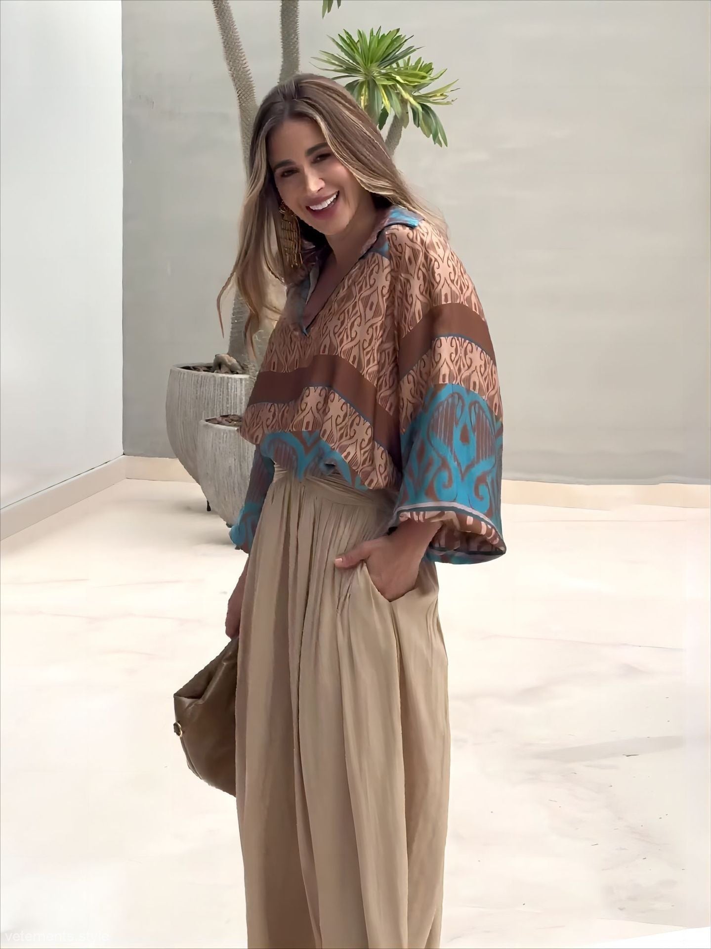 Elegant two piece set featuring woman in patterned blouse and wide-leg pants with free shipping