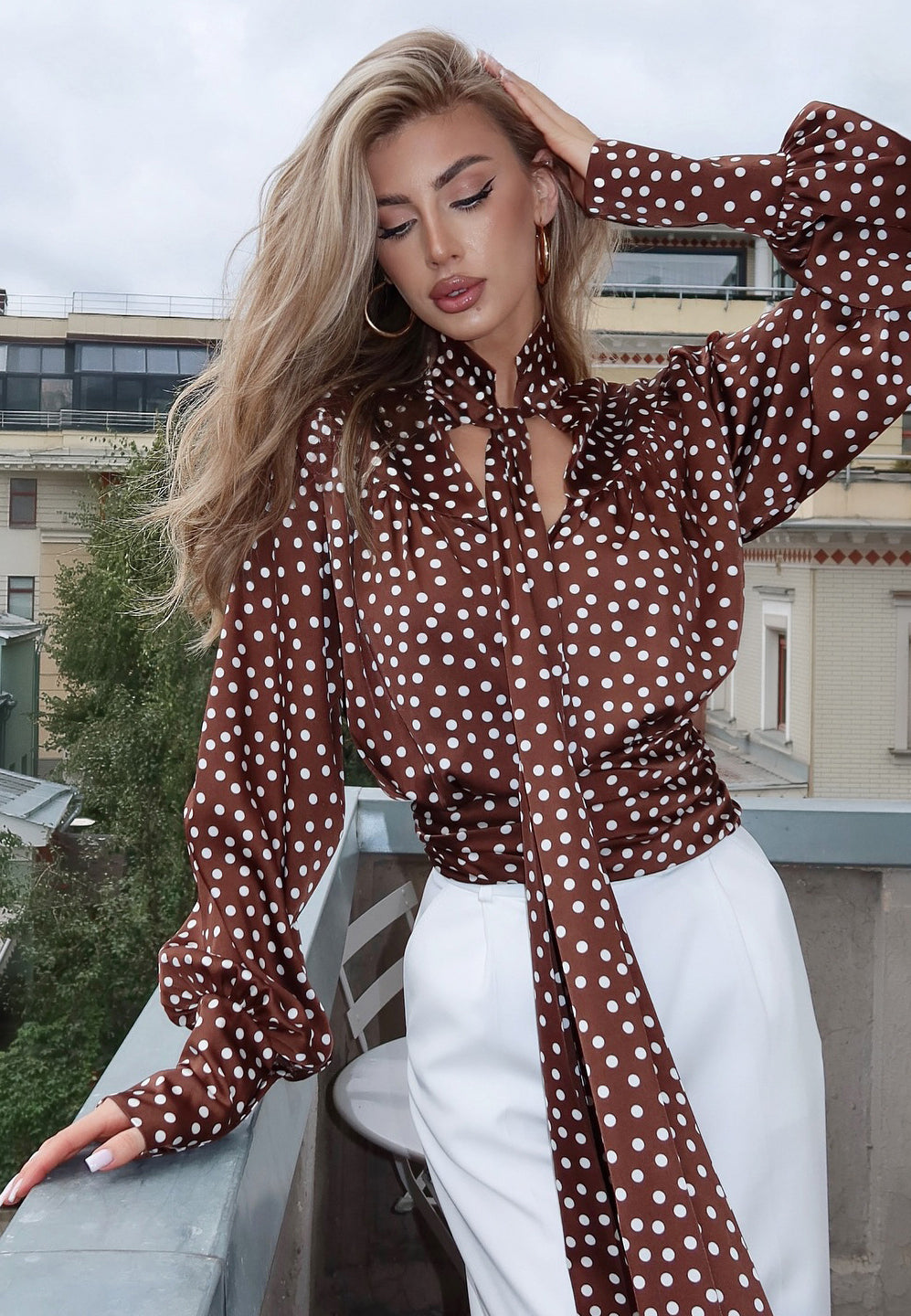 Elegance Polka Dot Shirt with ruffled sleeves and tie waist on brown background