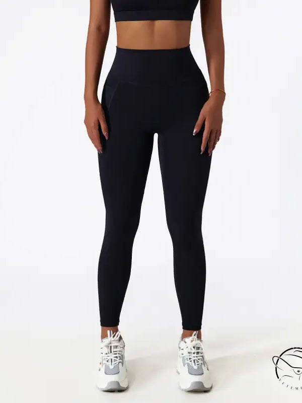 Black high-waisted yoga pants with white sneakers for Langry fashion