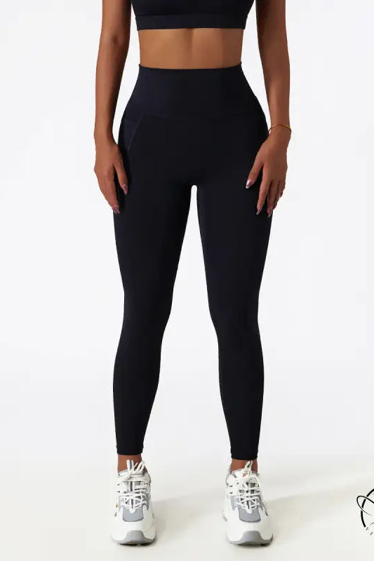 Black high-waisted yoga pants with white sneakers for Langry fashion