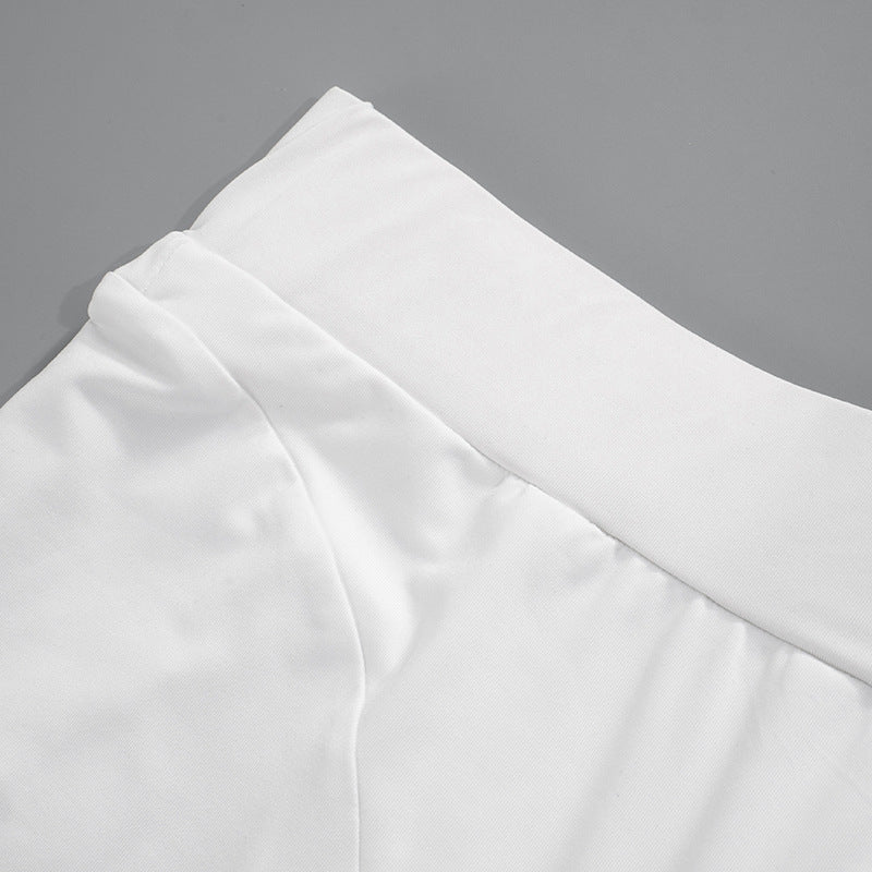 White fabric garment detail of women’s summer fashion slacks with high waist design
