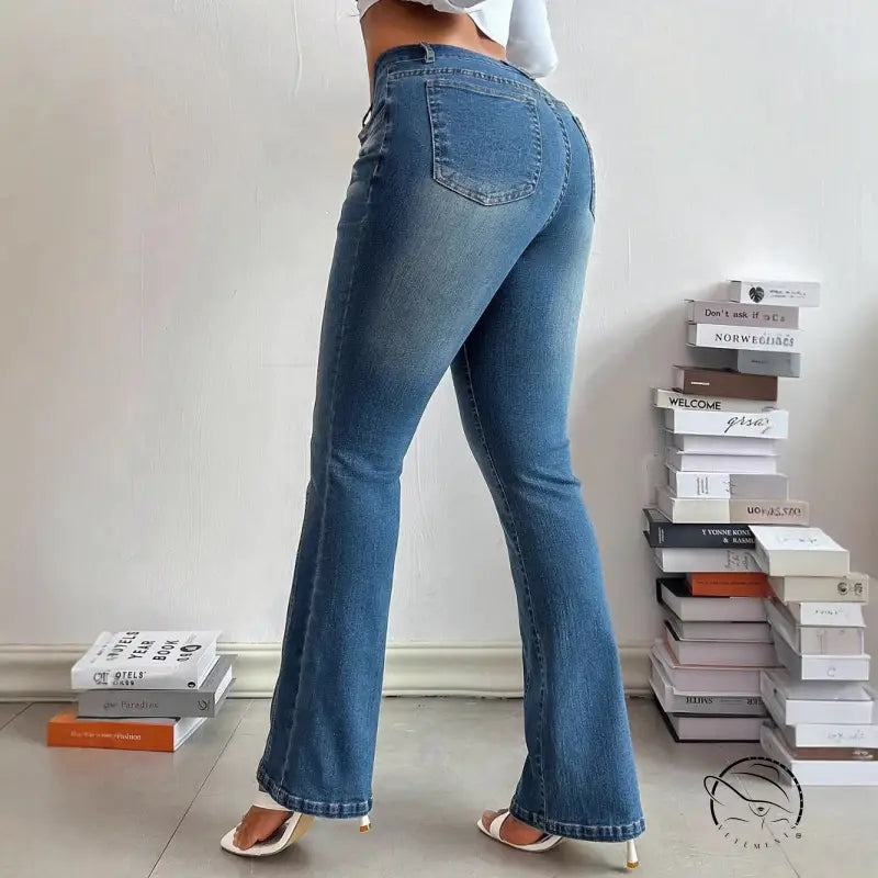 Person in casual slimming denim trousers with white high-heeled sandals