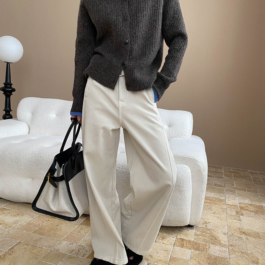 Dark gray knit cardigan with blue trim paired with white wide-leg pants for stylish fashion