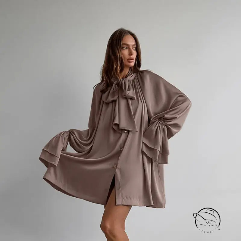 Elegant flowy taupe satin dress with oversized bow and billowing sleeves