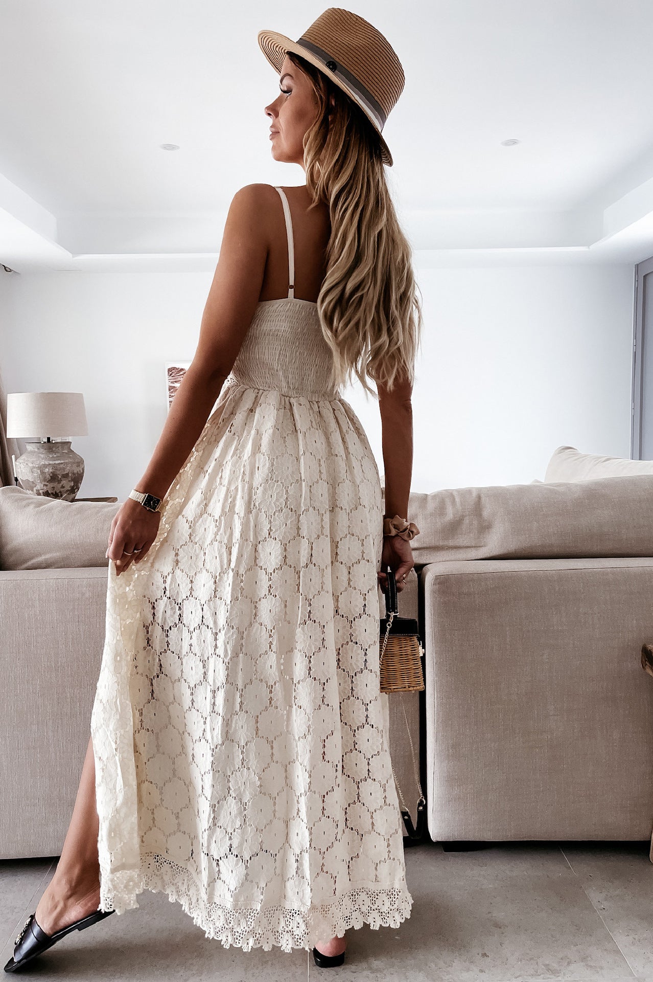 White lace maxi dress with spaghetti straps and flowing skirt showcasing elegant fashion ملابس