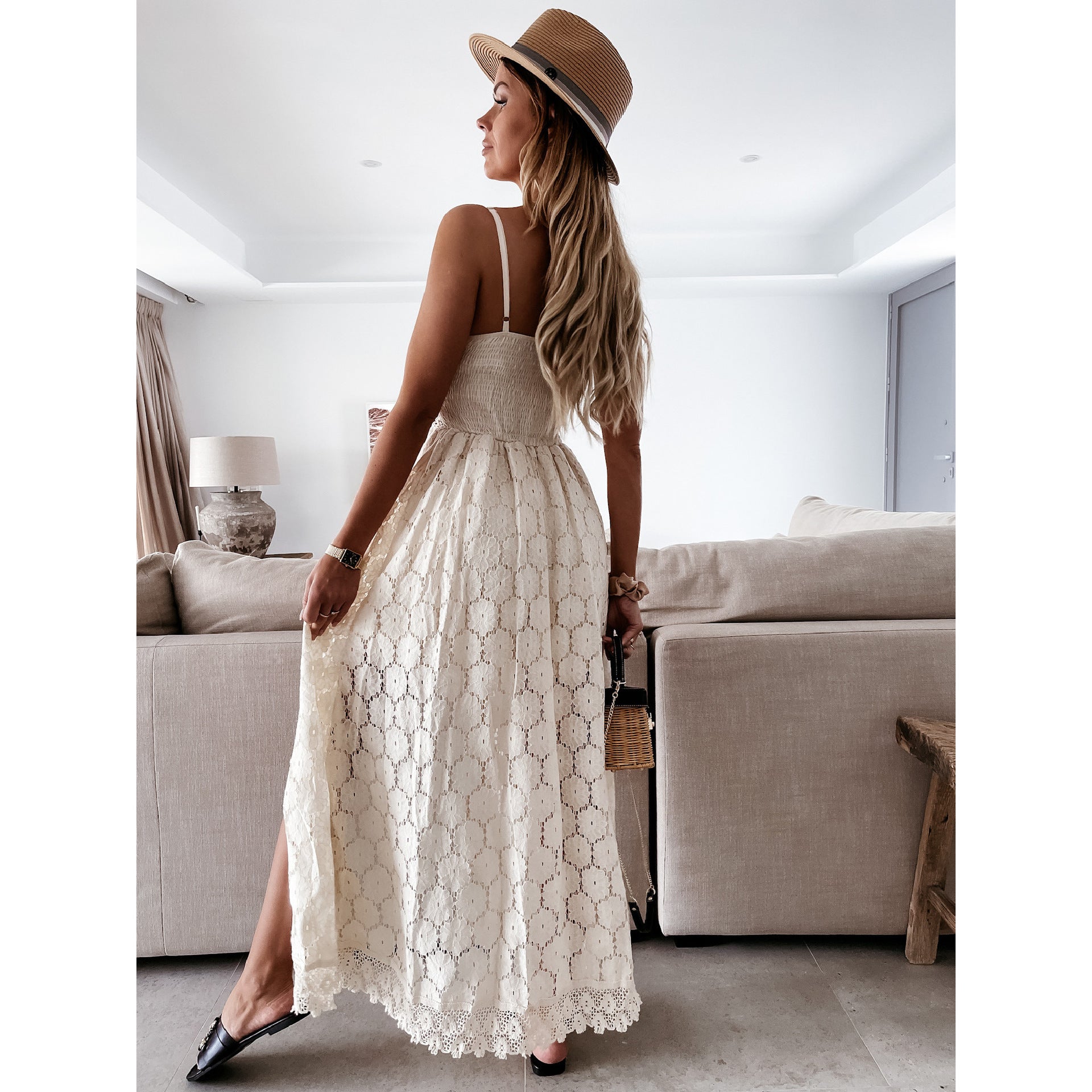 White lace maxi dress with spaghetti straps and flowing skirt showcasing elegant fashion ملابس