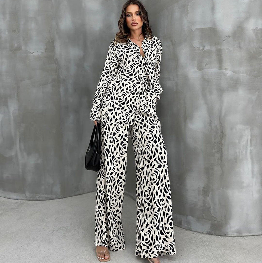 Woman wearing loose leopard print pajamas set with black and white patterned shirt and wide-leg pants