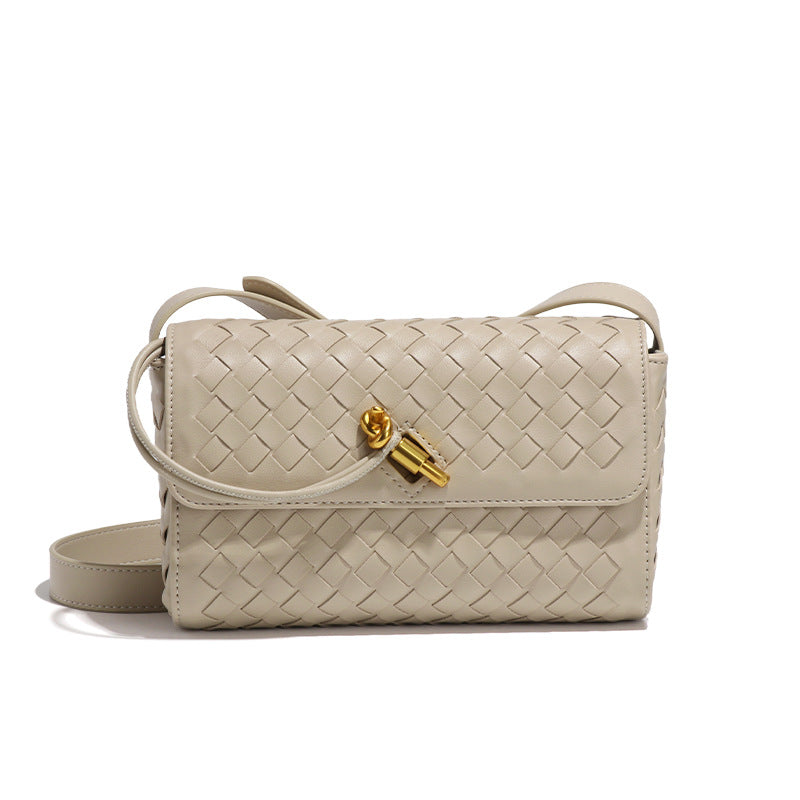 Beige woven leather shoulder bag with gold hardware, perfect for elegant fashion ensembles