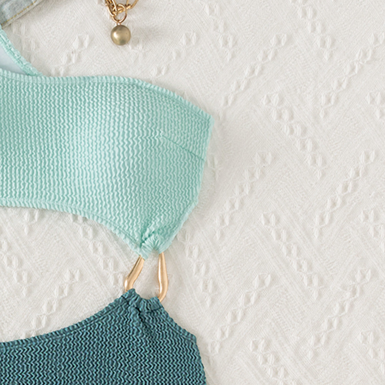 Mint and teal knitted fabric connected by gold hardware in a Stunning Hollow Out Bikini