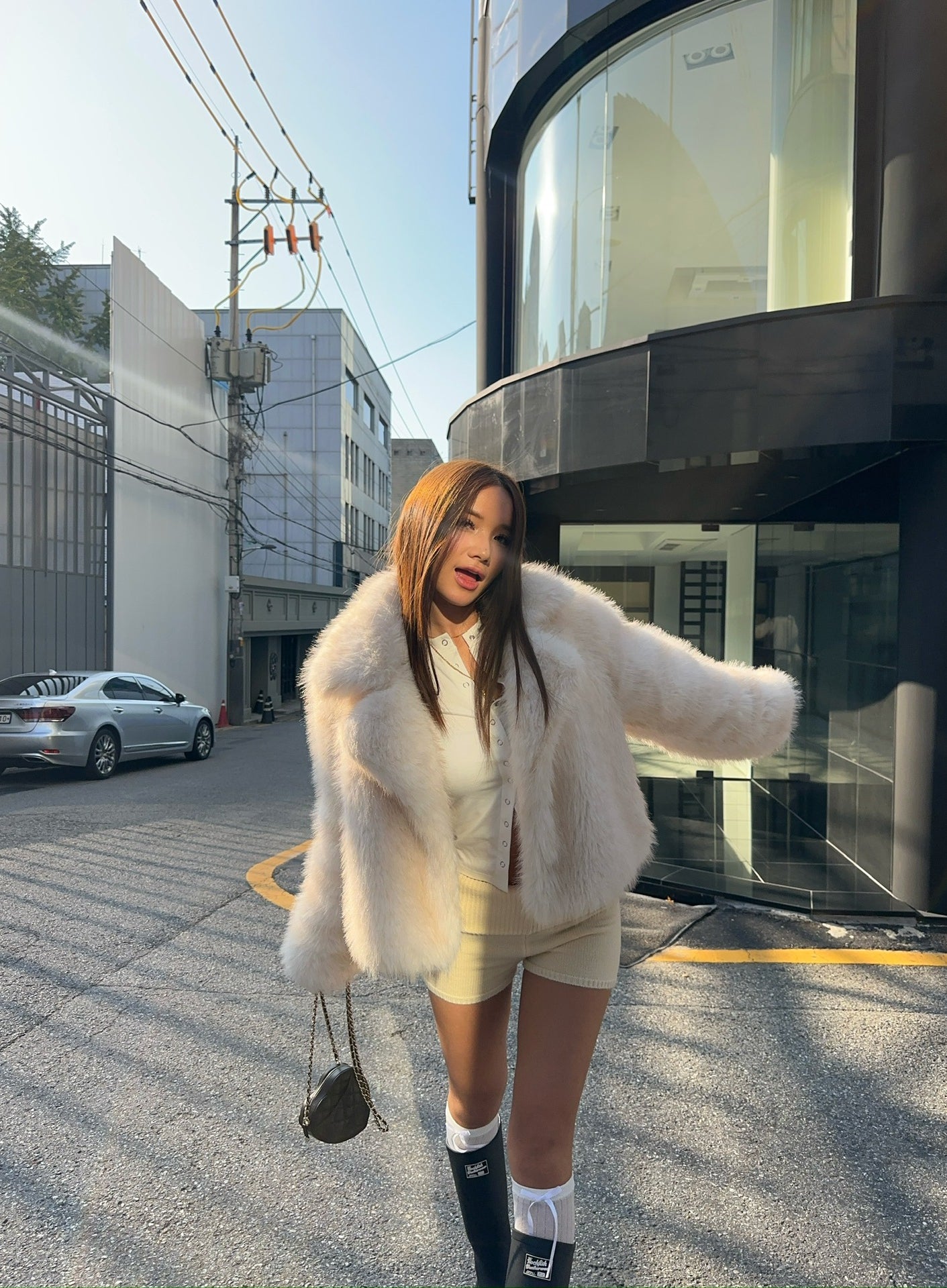 Cream faux fur oversized coat with black and white striped socks, Langry fashion