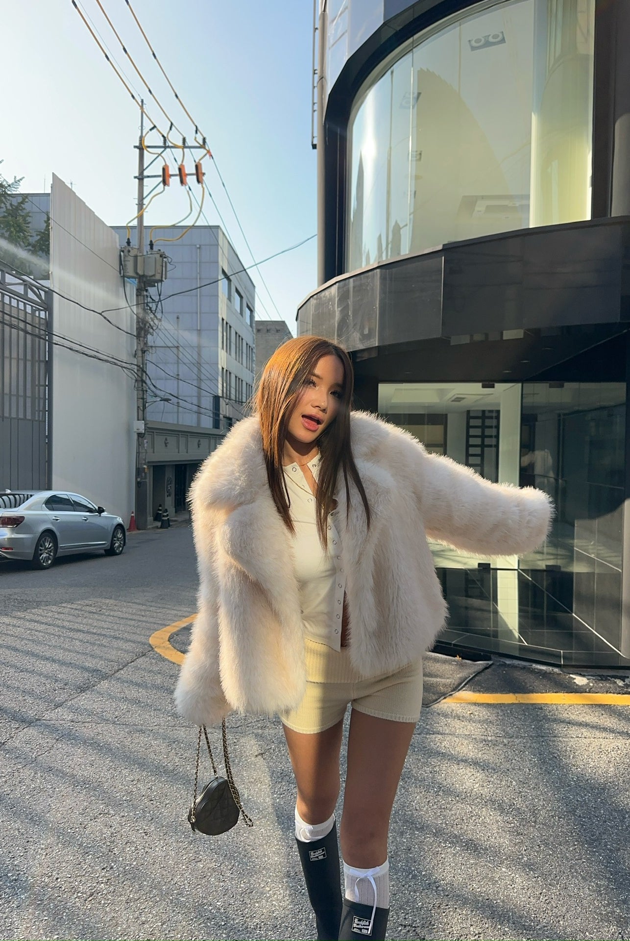 Cream faux fur oversized coat with black and white striped socks, Langry fashion