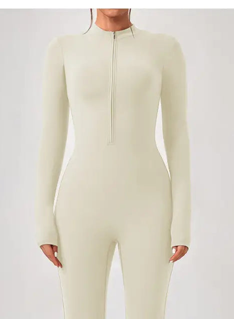 Cream-colored long-sleeve one piece sportswear with front zipper neckline