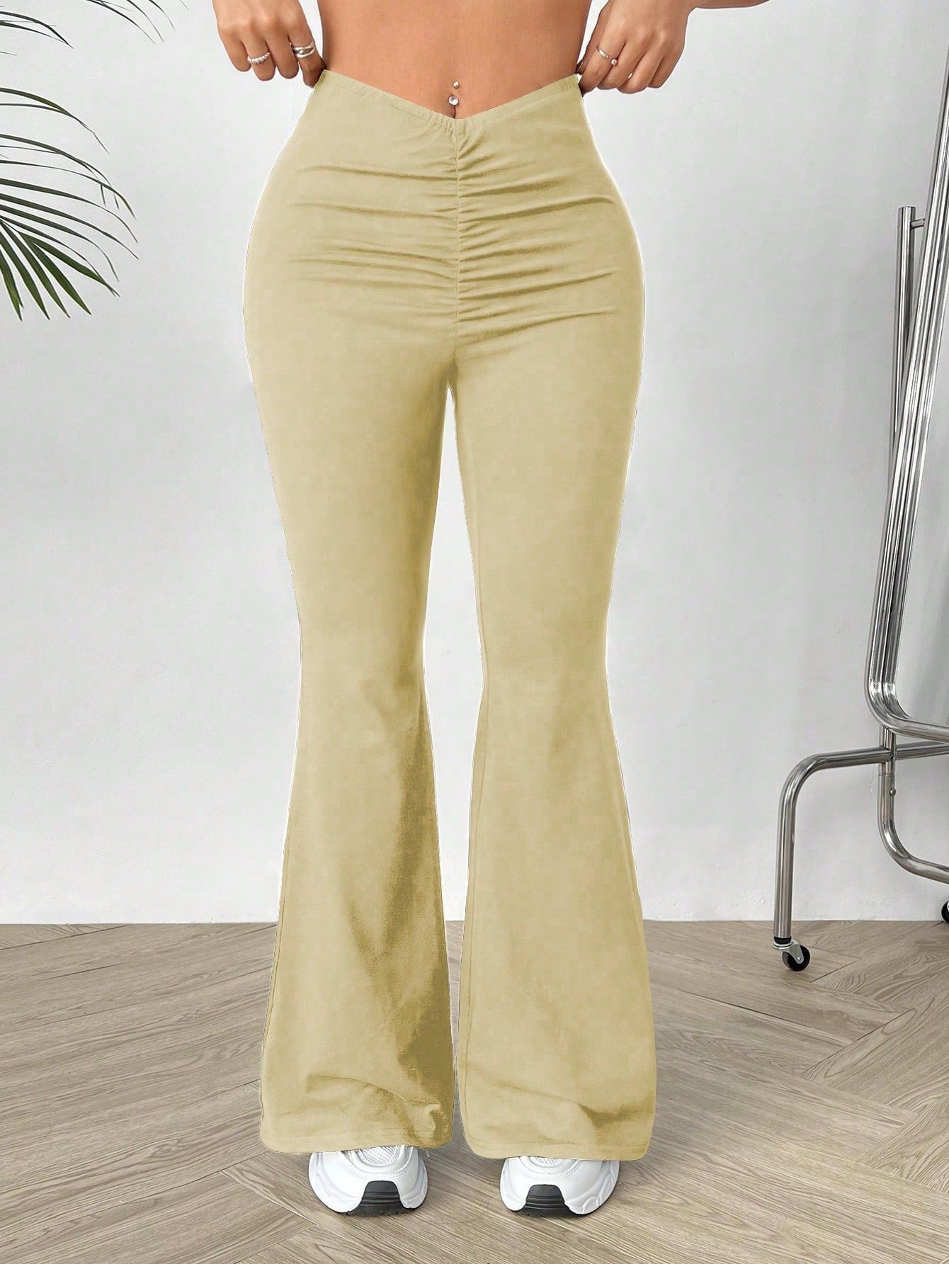 Women’s high-waisted beige slimming bootcut trousers with ruched flared design for shaped waist