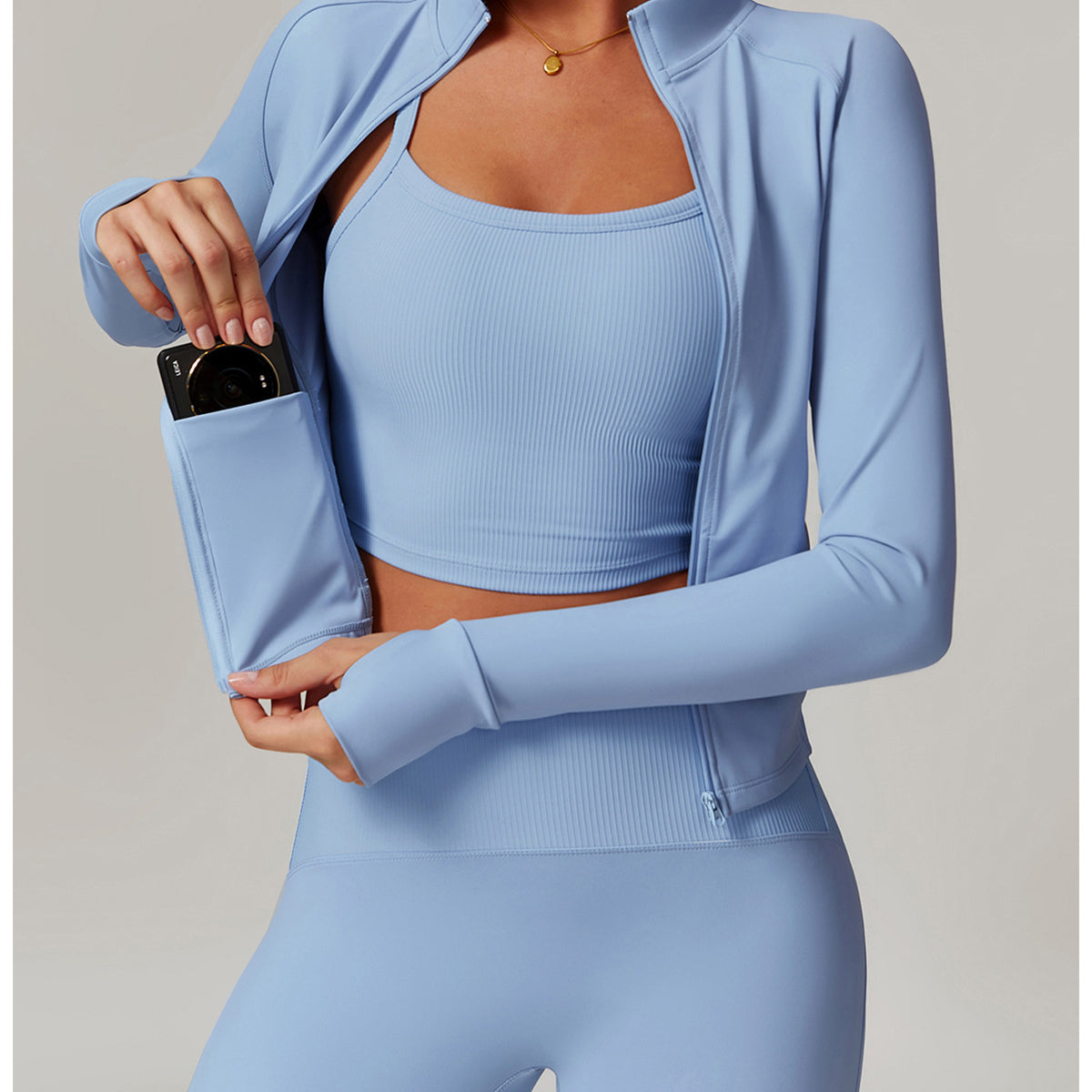 Light blue langry workout set with cropped jacket, sports bra, and leggings in ribbed fashion