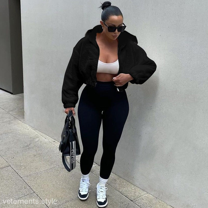 Woman wearing black jacket with leggings and sneakers in autumn hooded plush long