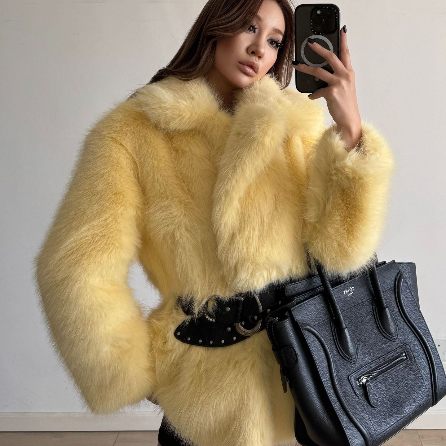 Yellow fluffy faux fur coat with black belt and Celine bag