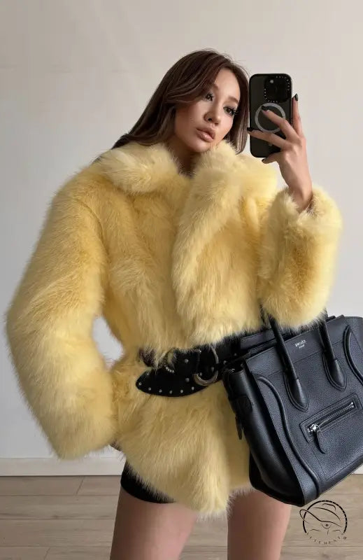 Yellow fluffy faux fur coat with black belt and Celine bag