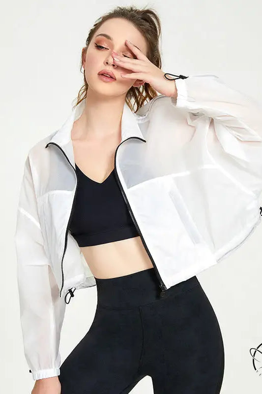 Woman in white translucent cropped casual loose cardigan for yoga