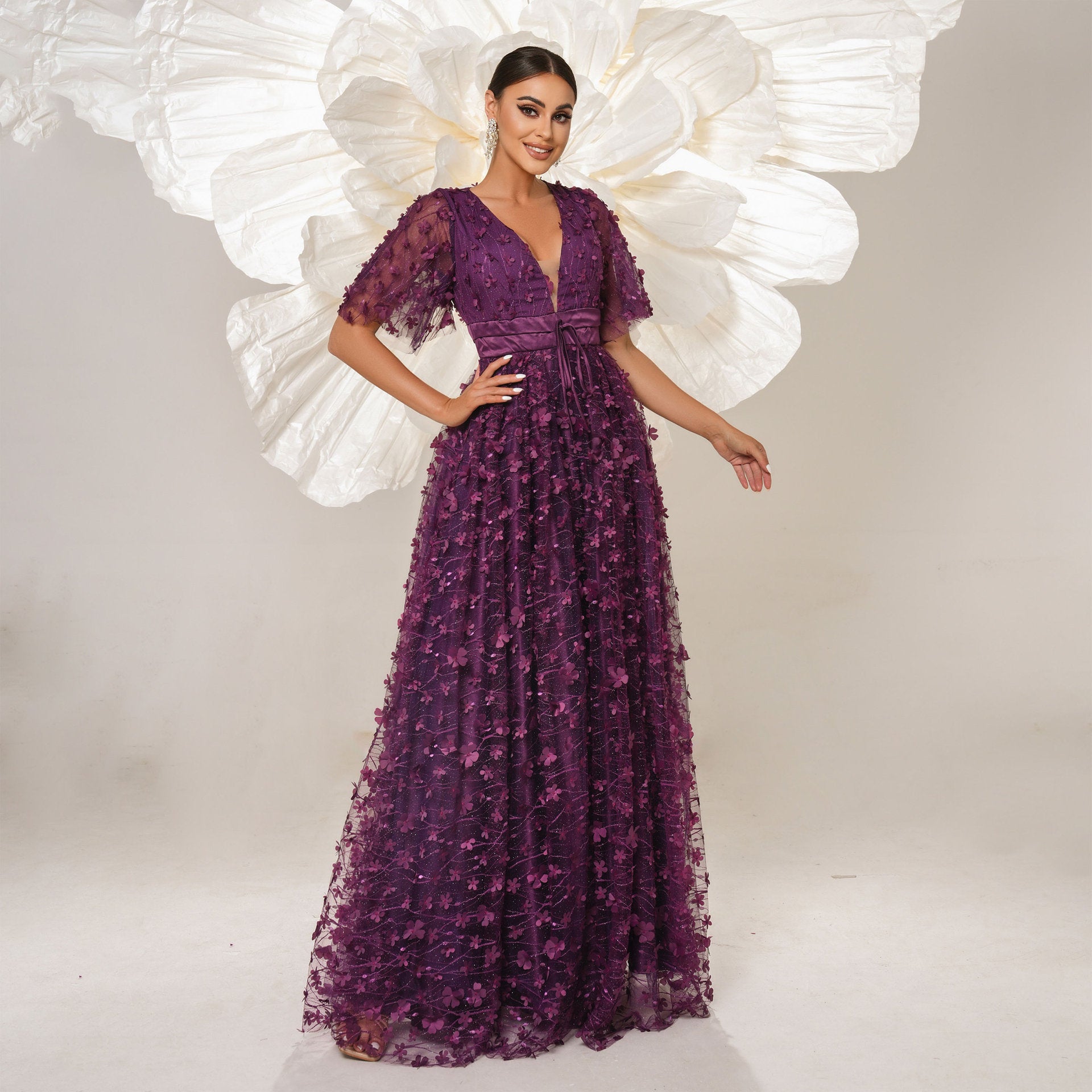 Elegant purple floral gown showcasing high-end fashion and ملابس for special occasions