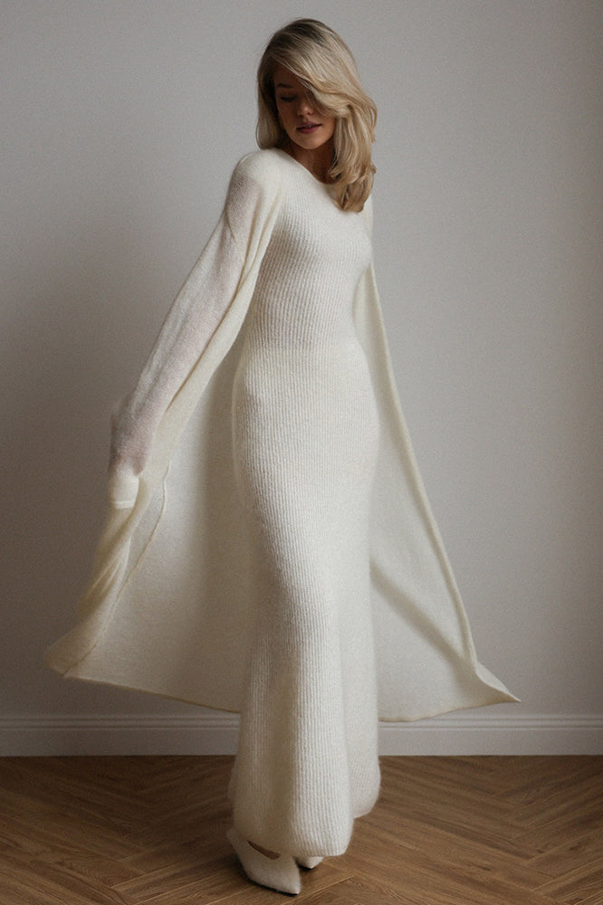 Cream-colored knitted cardigan sleeveless dress with long sleeves and flowing skirt