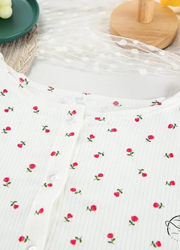 White ribbed knit langry top with red rose print and button closure