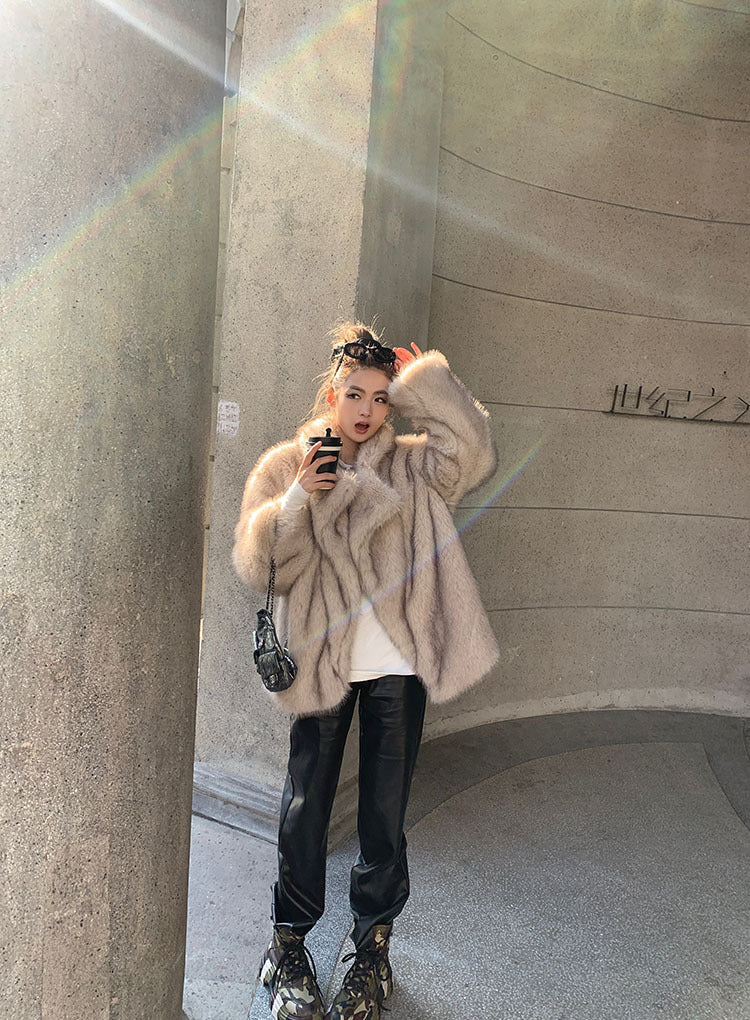 Beige faux fur oversized coat with leather accents and floral headband