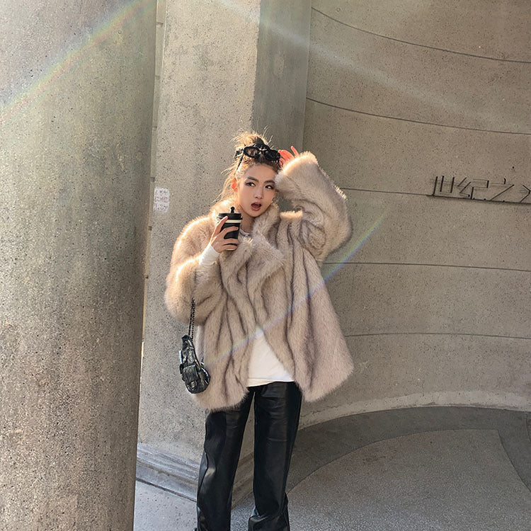 Beige faux fur oversized coat with leather accents and floral headband