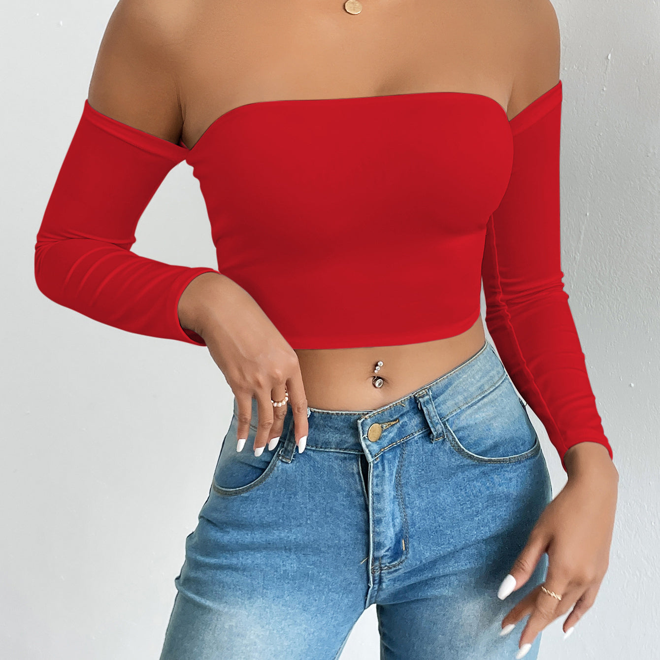 Red off-the-shoulder crop top with light wash jeans, stylish ملابس for fashion enthusiasts