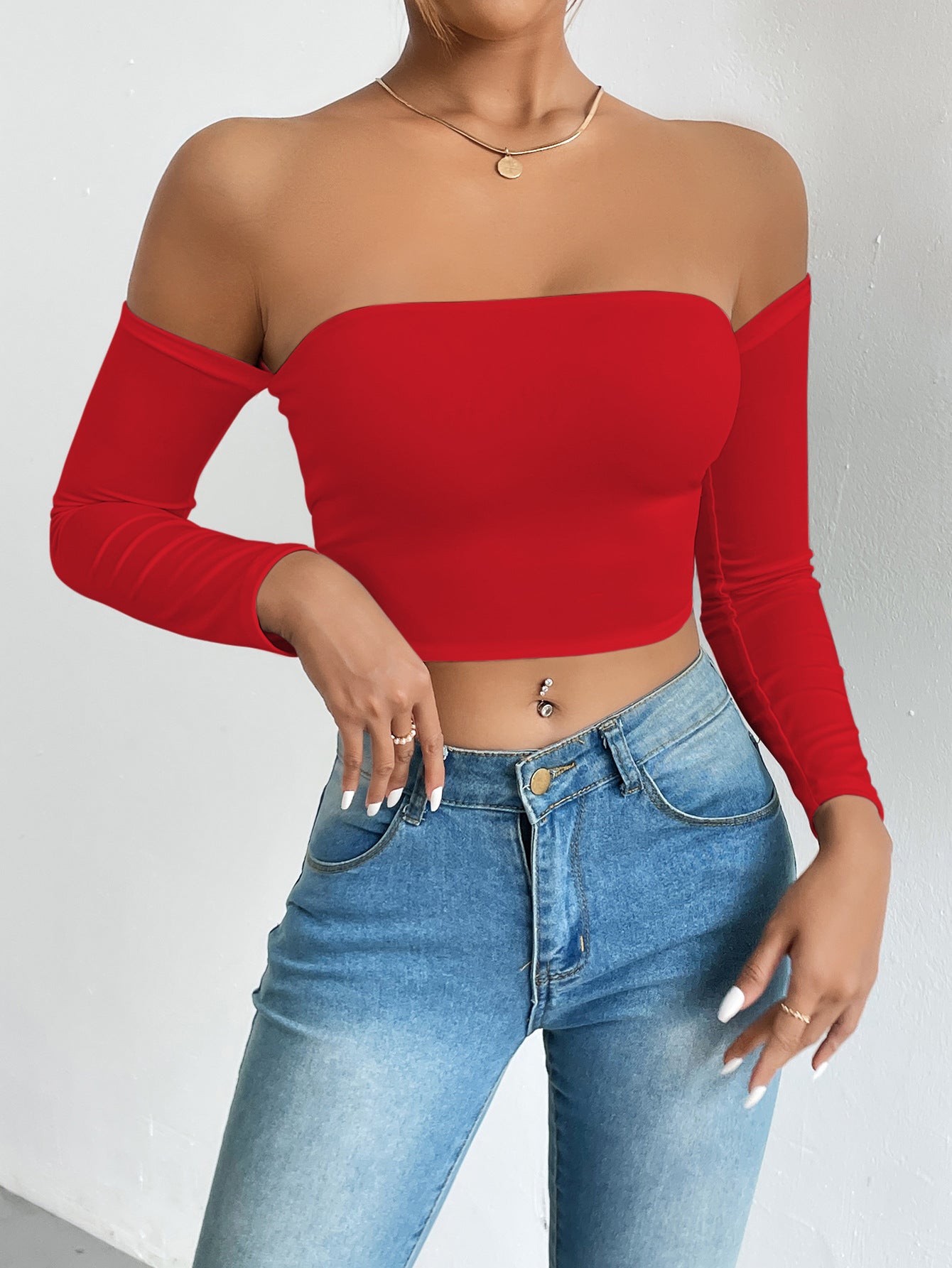 Red off-the-shoulder crop top with light wash jeans, stylish ملابس for fashion enthusiasts