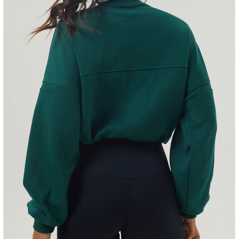 Emerald green long sleeve rugby shirt with black leggings for stylish autumn fashion