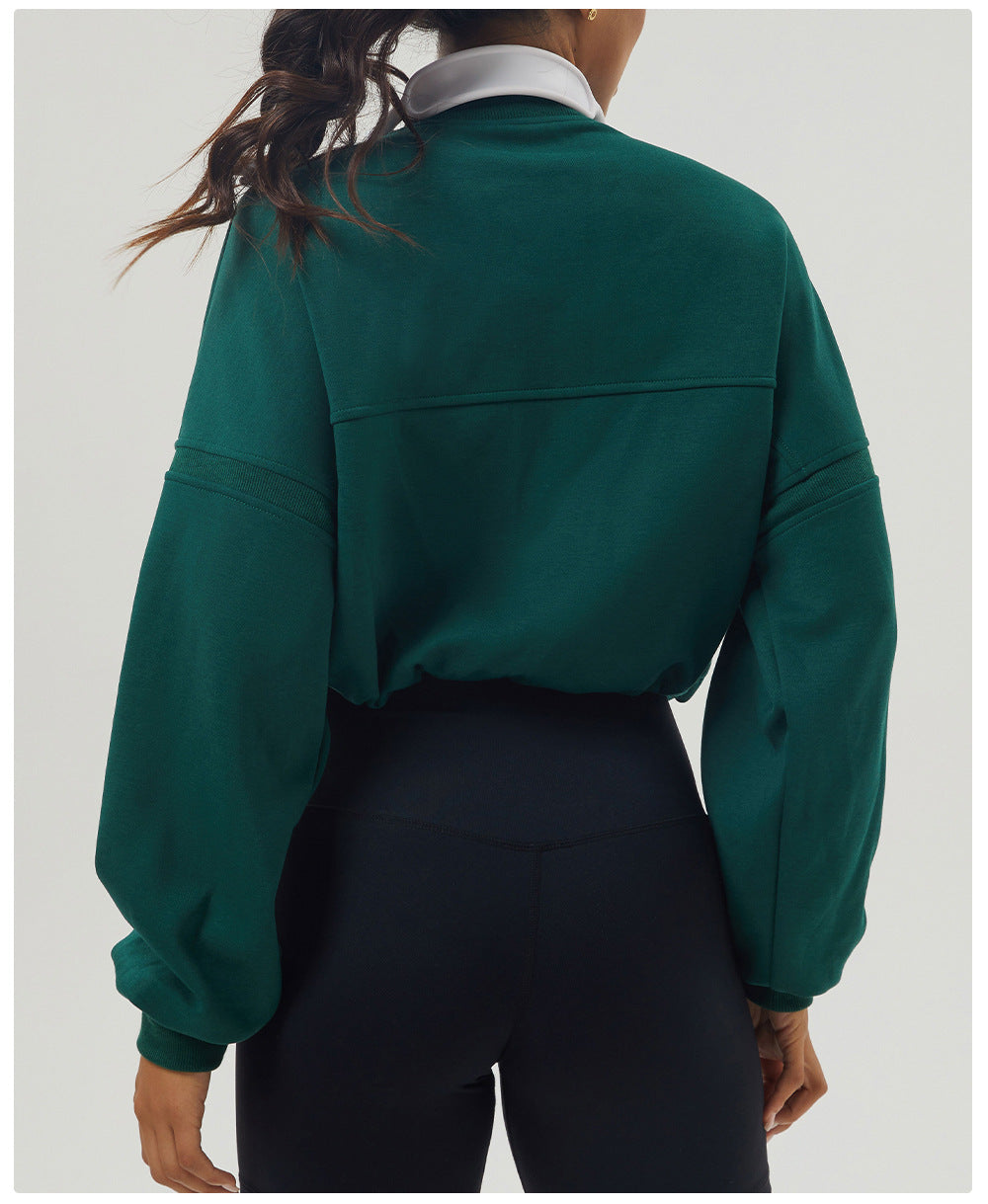 Emerald green long sleeve rugby shirt with black leggings for stylish autumn fashion