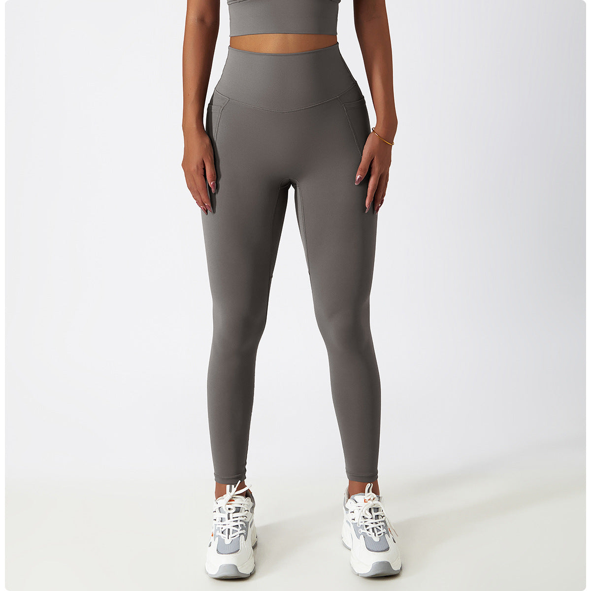 High-waisted gray athletic leggings with white sneakers for stylish yoga fashion