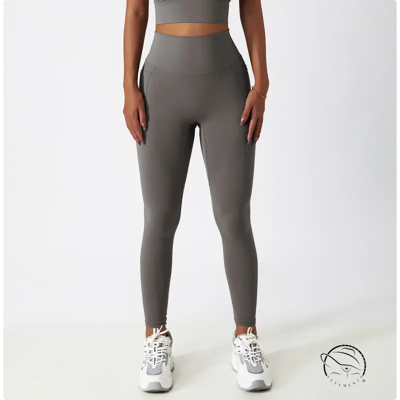 Breathable high-waisted gray yoga pants with white sneakers