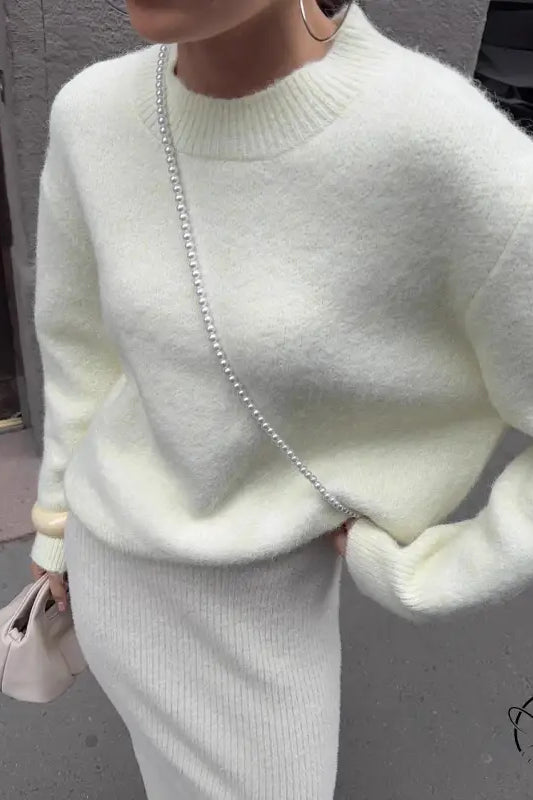 Winter loose long wool alpaca sweater with white fluffy design, ribbed hem, cuffs, pearl chain strap