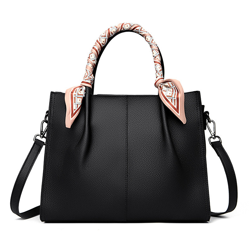 Elegant langry genuine leather handbag in black with floral handles and gold hardware