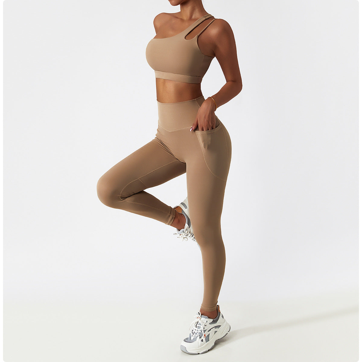 Beige workout set with sports bra and high-waisted leggings for stylish fitness fashion ملابس