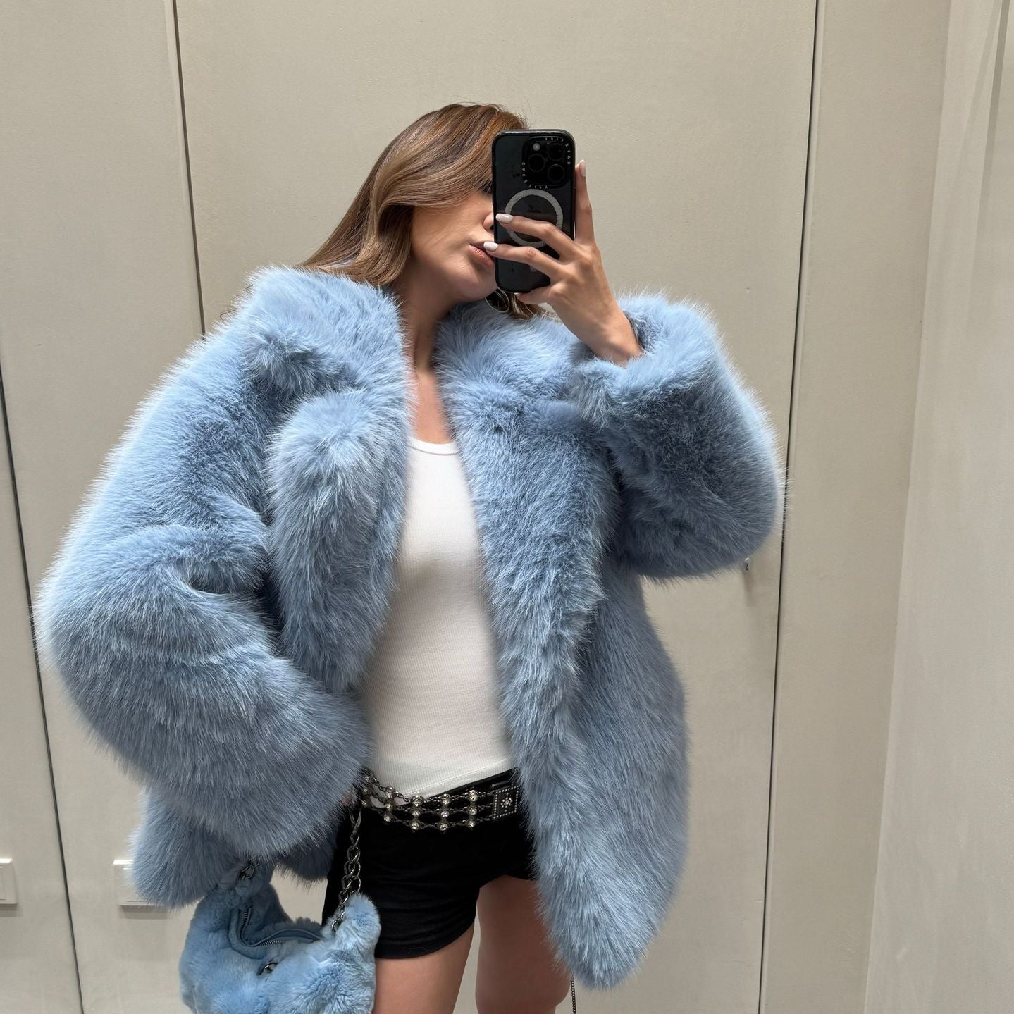 Light blue faux fur coat with oversized sleeves and plush texture