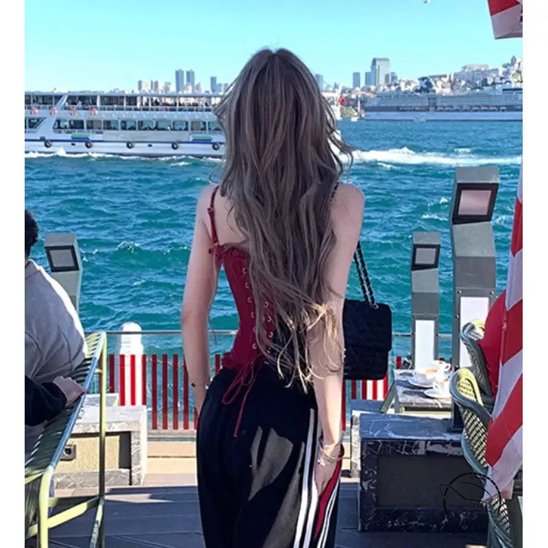 Handmade lace boning corset top in red with striped skirt and black handbag