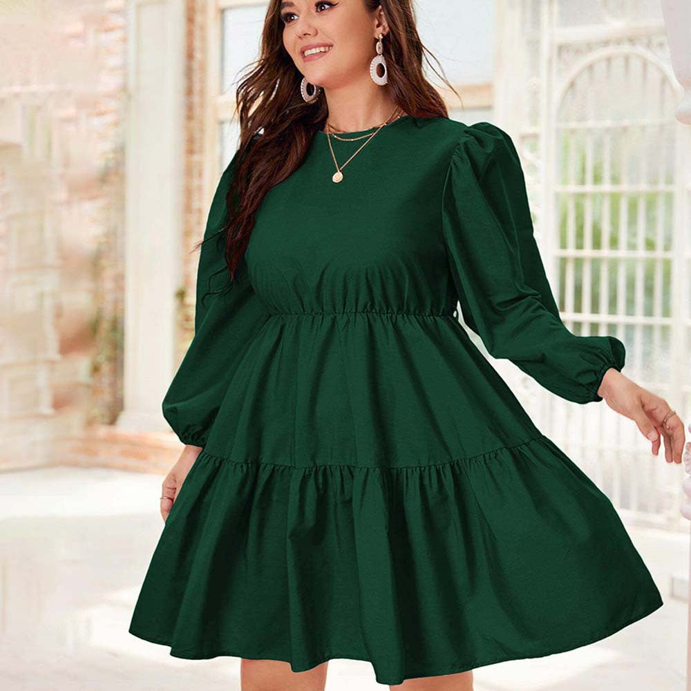 Emerald green tiered dress showcasing elegant lantern sleeve design in modern fashion