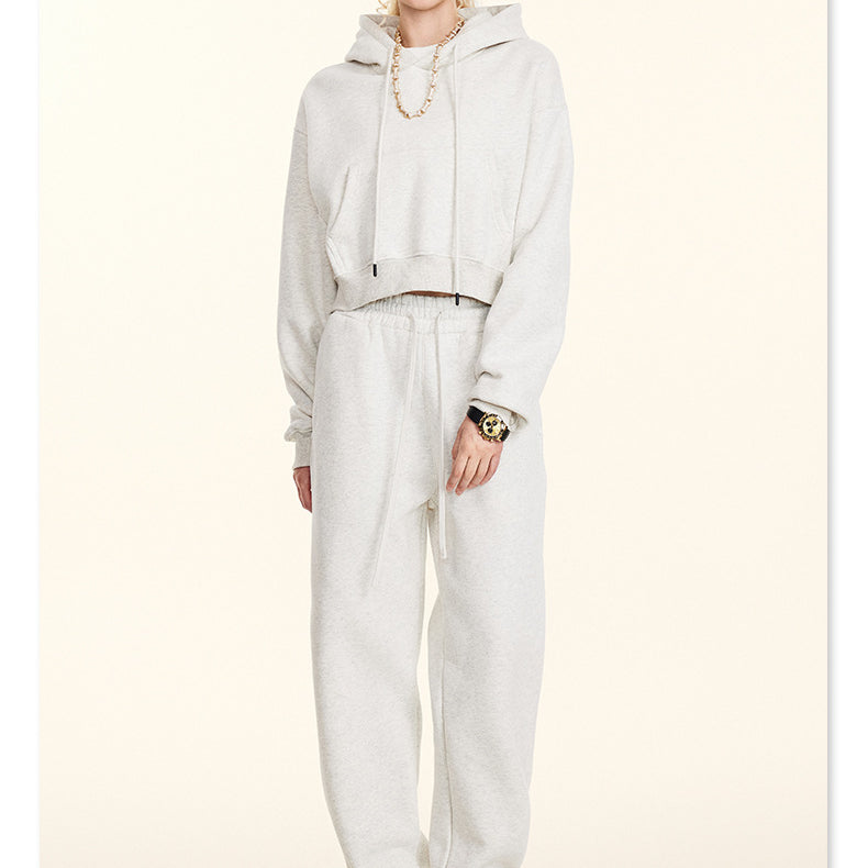 All-white sweatsuit ensemble featuring a hooded top and loose-fitting pants for winter fashion