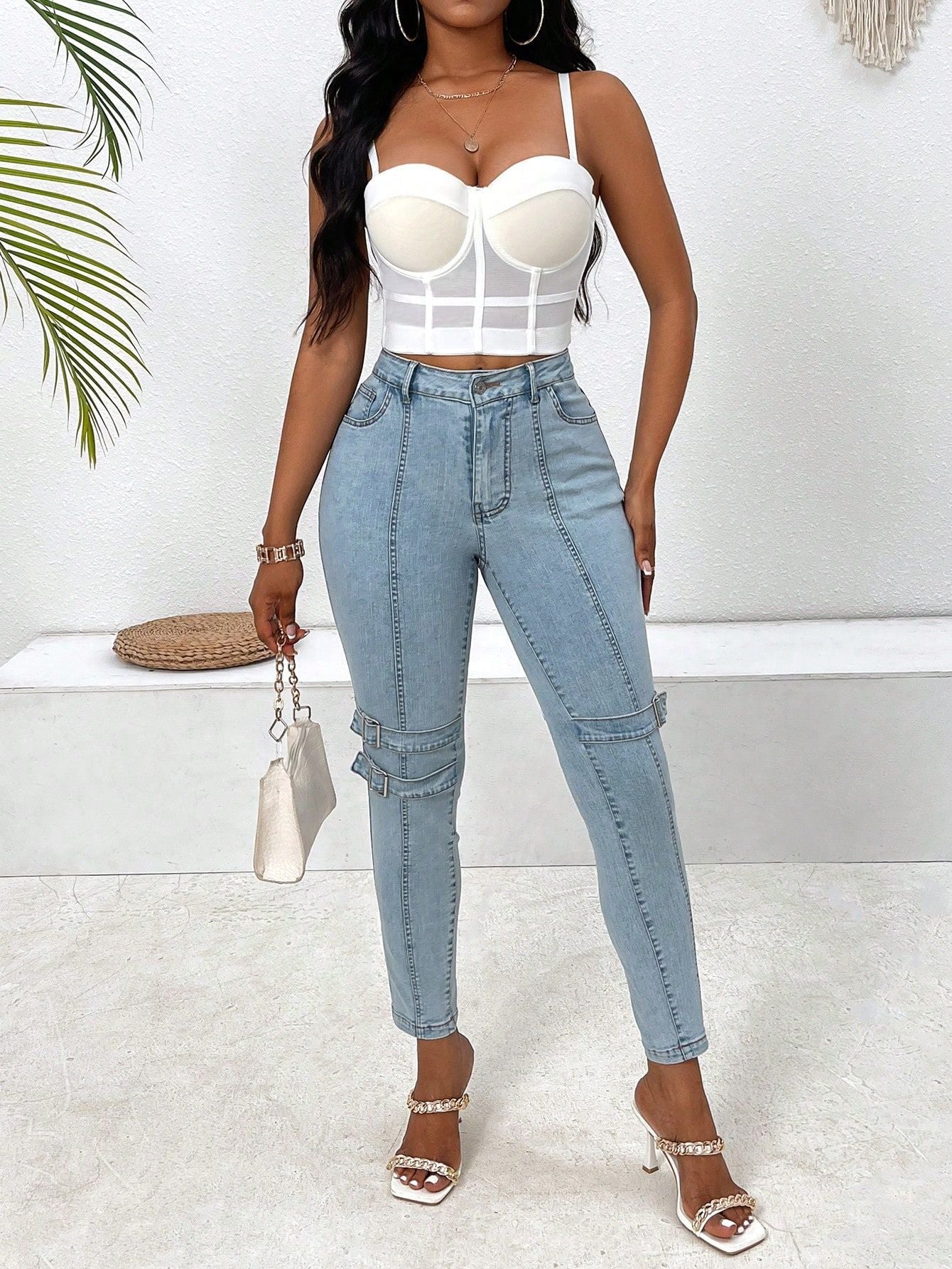 High elastic skinny jeans featuring light blue fabric and embellished knee details