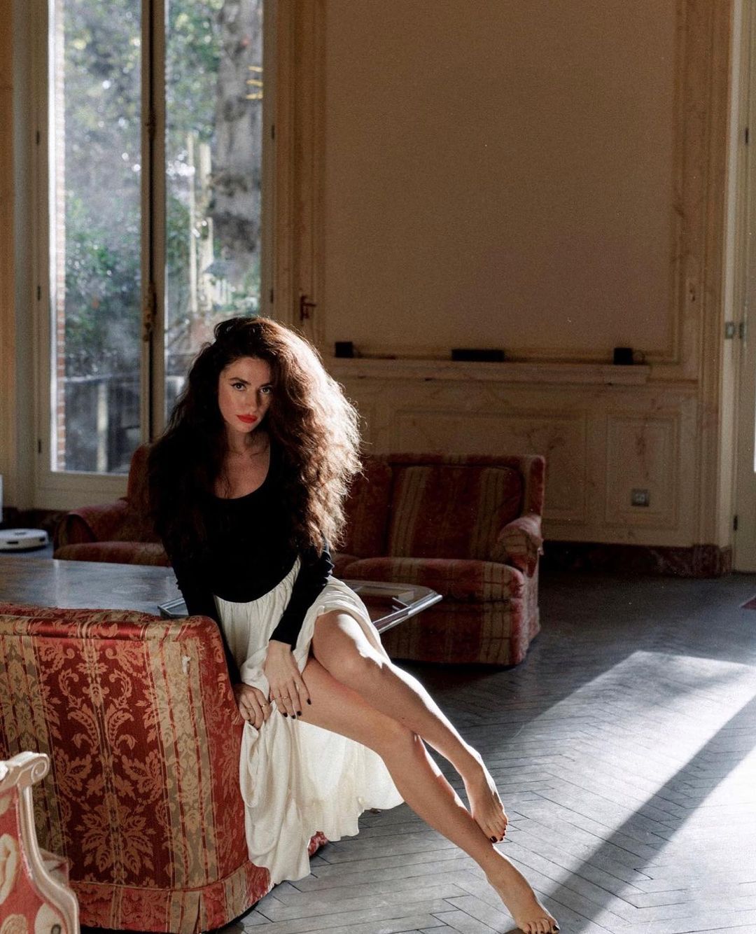 Woman in Elegant Hepburn Dress showcasing langry fashion on ornate fabric surface