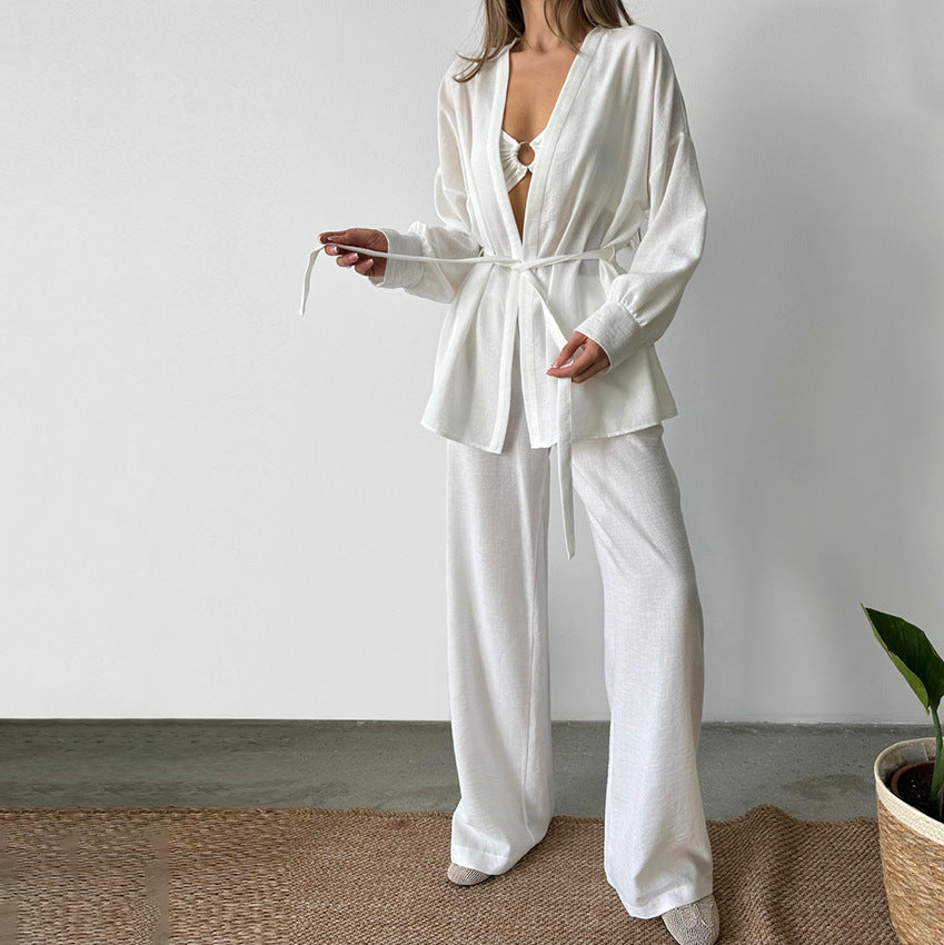 Women’s white satin two-piece resort wear set with tie-waist top and wide-leg trousers, ideal for comfy cotton linen pajamas