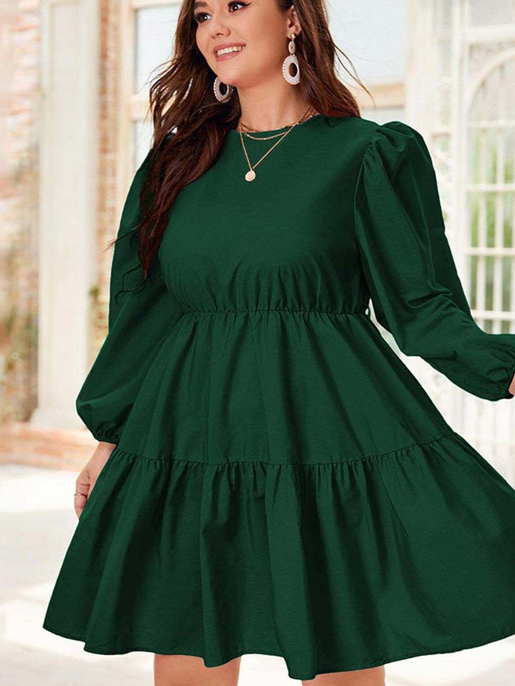 Emerald green tiered dress featuring stylish lantern sleeves, perfect for elegant fashion