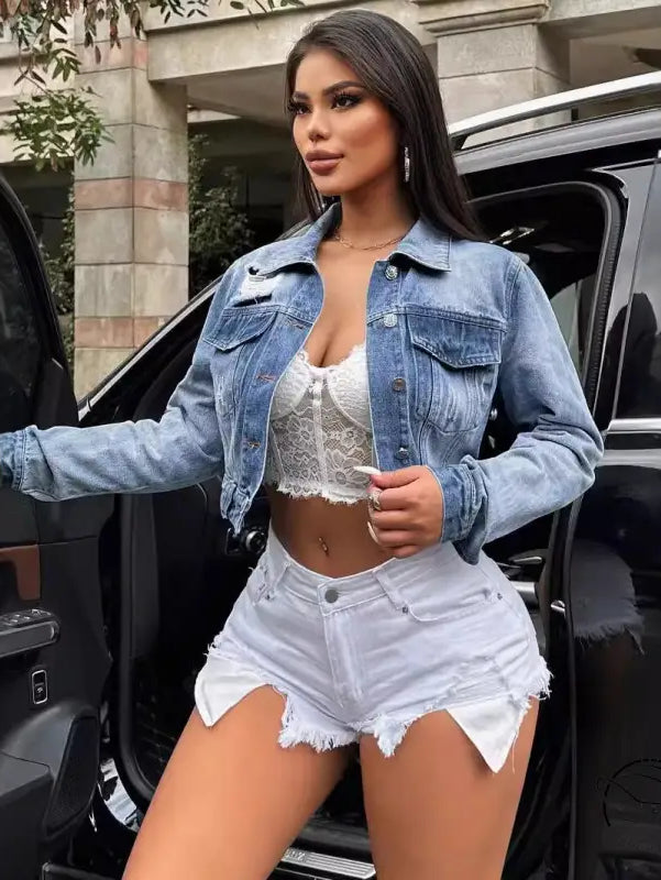 Woman in loose short denim coat with white lace top and shorts
